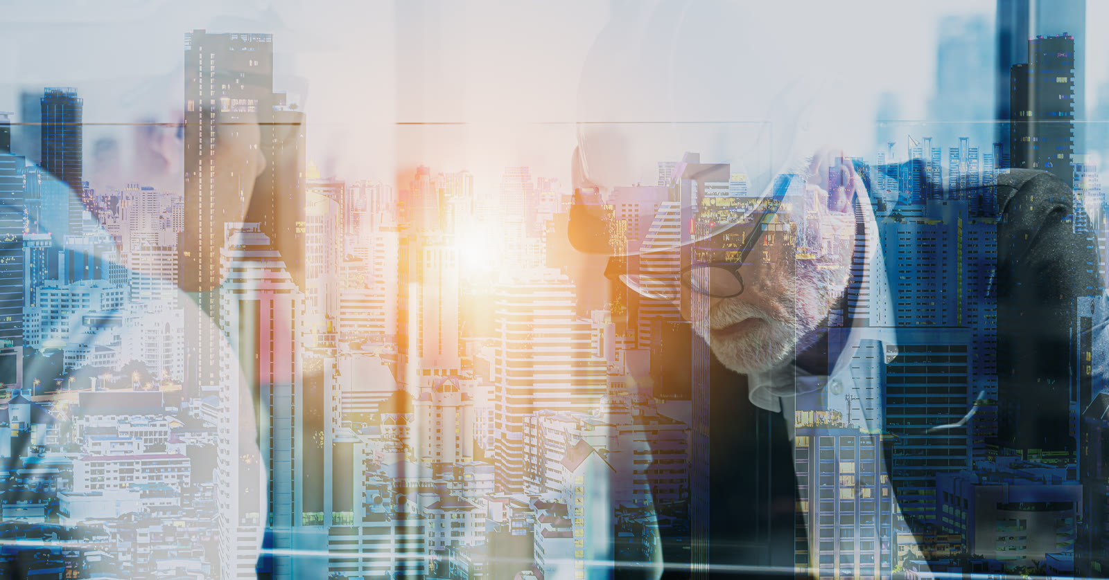 Senior professionals in discussion - double exposure with city skyline